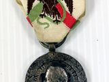 an image of a medal with a picture of an eagle on it