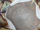 a close up of a brown and white vase with writing on it