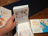 a person that is opening a book on a table