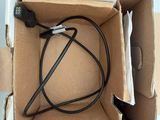 a box with a cable and a charger inside of it