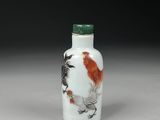 an image of a white and red glass snuff bottle with a bird on it