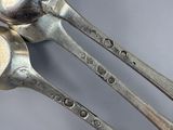 two spoons that are sitting next to each other