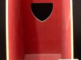 a red cardboard box with a yellow handle on a black background