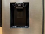a stainless steel refrigerator with a water dispenser on the door