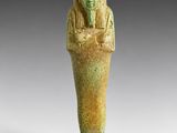 an egyptian statue of a man holding a bowl of food