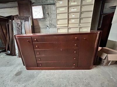an image of a dresser in a room with many boxes
