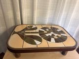 a coffee table with a mosaic design on top of it