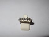 a close up of a diamond ring on a white surface