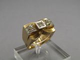 an image of a gold and diamond ring on a clear stand