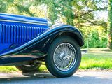 a blue car that is parked on the side of the road