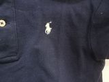 a close up of a polo shirt with buttons on the chest