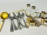 a lot of silver spoons and silverware on the table