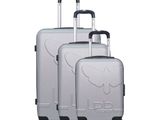 three pieces of luggage sitting on top of each other on a white surface