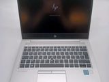 hp laptop computer on a white table with a blurry image in the background