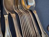 a lot of silver spoons and spoon spoons on a table