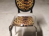 a chair that has a leopard print seat on it