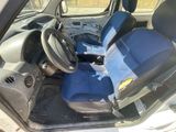the interior of a car with a blue seat cover and a steering wheel
