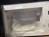 a microwave with a plastic bag inside of it