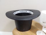 a black top hat sitting on top of a wooden table