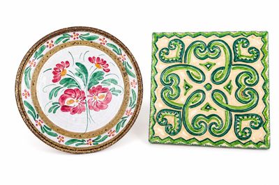 two decorative plates with designs on them are sitting next to each other
