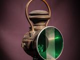 a green light that is on top of a lamp