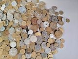 a pile of coins sitting on a white surface