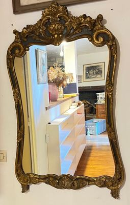 a mirror hanging on the wall next to a dresser