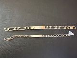 a pair of gold bracelets on a black leather surface