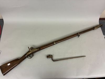 a rifle with a wooden handle and a wooden handle on a table