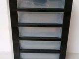 a black plastic drawer with six drawers on it