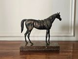 a statue of a horse that is standing on a marble base