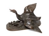 bronze sculpture of a duck and a duckling on a plate