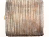 an antique silver cigarette case on a white background