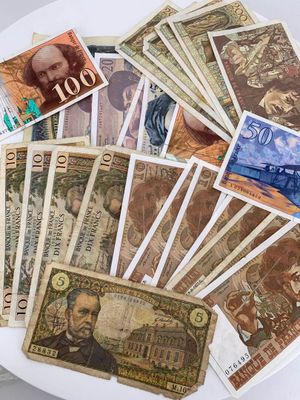 a white plate with many different bank notes on it