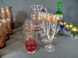 a lot of glasses and pitchers on the table