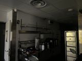 an image of a commercial kitchen with a lot of clutter