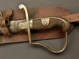 a knife that is laying on top of a leather case
