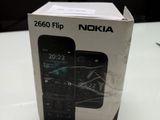 boxed box of nokia flip phone sitting on a table in a room
