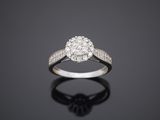 a diamond cluster ring on a black surface