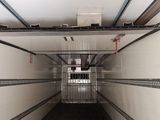an image of a long hallway with a metal door