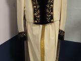 a mannequin in the corner of a room with a dress on it