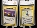 the two cards are in plastic holders on a black background