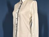 an image of a white shirt on a mannequin stand