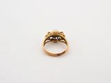 a close up of a gold ring on a white surface