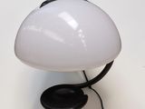 a white mushroom shaped lamp with a black base