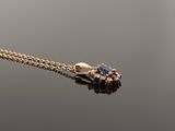 an image of a diamond and gold necklace on a black surface