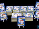 a lot of cards with pokemon on them sitting on a table
