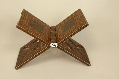 an old wooden box with a dice in it on a white surface