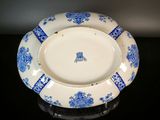 a blue and white plate sitting on a black table