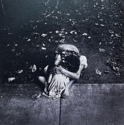 a black and white photo of a child on the sidewalk